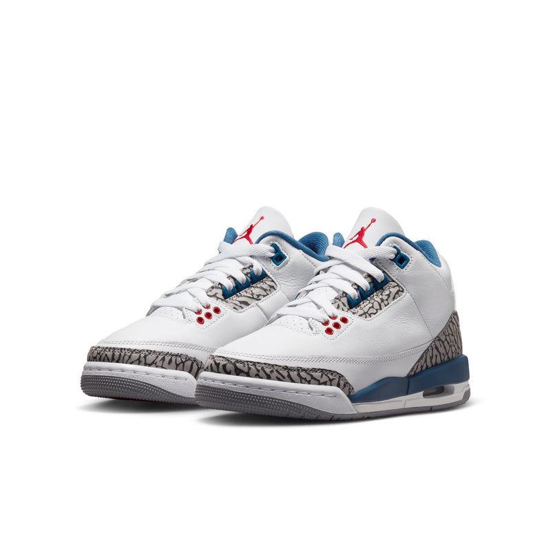 Youth white leather sneakers, side view, blue midsole, elephant-print panel, and red eyelets