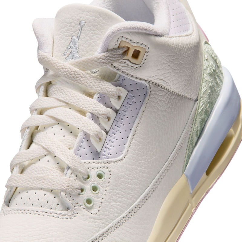 Youth sneaker upper close-up, white leather with sage trim and lace eyelets