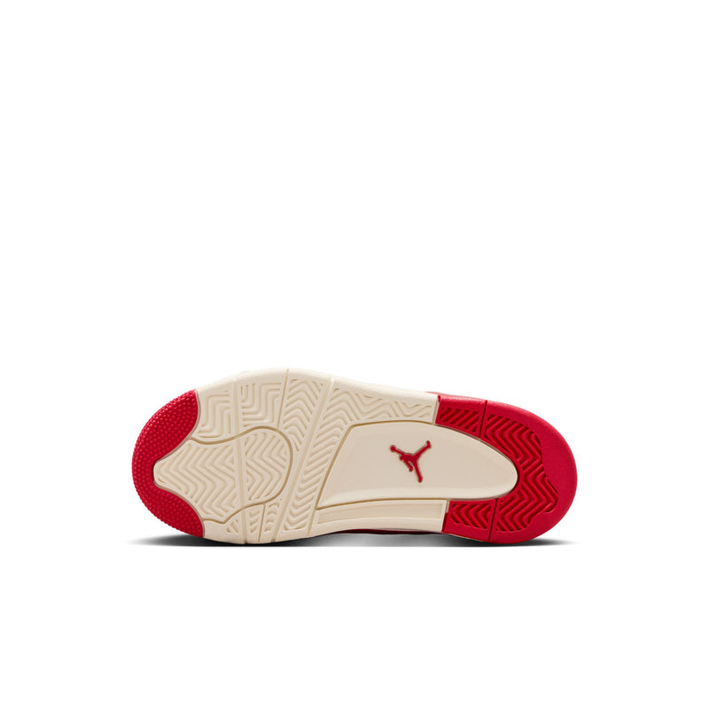 Kids sneaker outsole view: pale midsole with red rubber traction and Jumpman logo