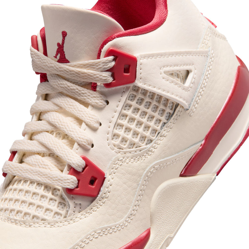 Kids sneaker close-up: pale ivory mesh quarter with red lace-up hardware and Jumpman