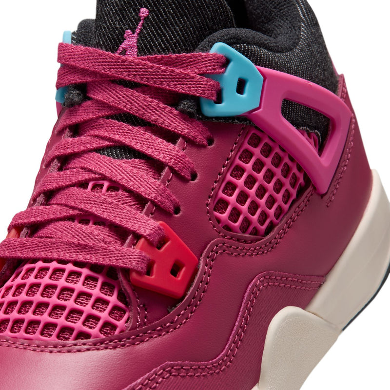 Close-up of kids' burgundy sneakers: pink laces, black collar, teal lace lock