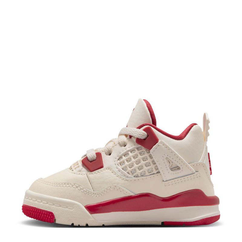 Kids' high-top sneaker side view, pale ivory upper with red straps and trim