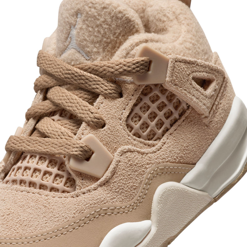 Close-up of tan toddler sneaker upper with knit mesh window, laces, and heel strap