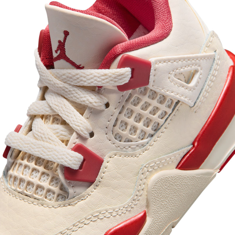 Kids' high-top sneaker close-up, pale ivory mesh panels with red lace eyelets