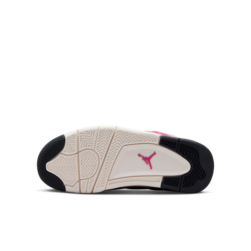 Youth sneaker outsole with traction pattern and pink Jumpman logo on beige midsole