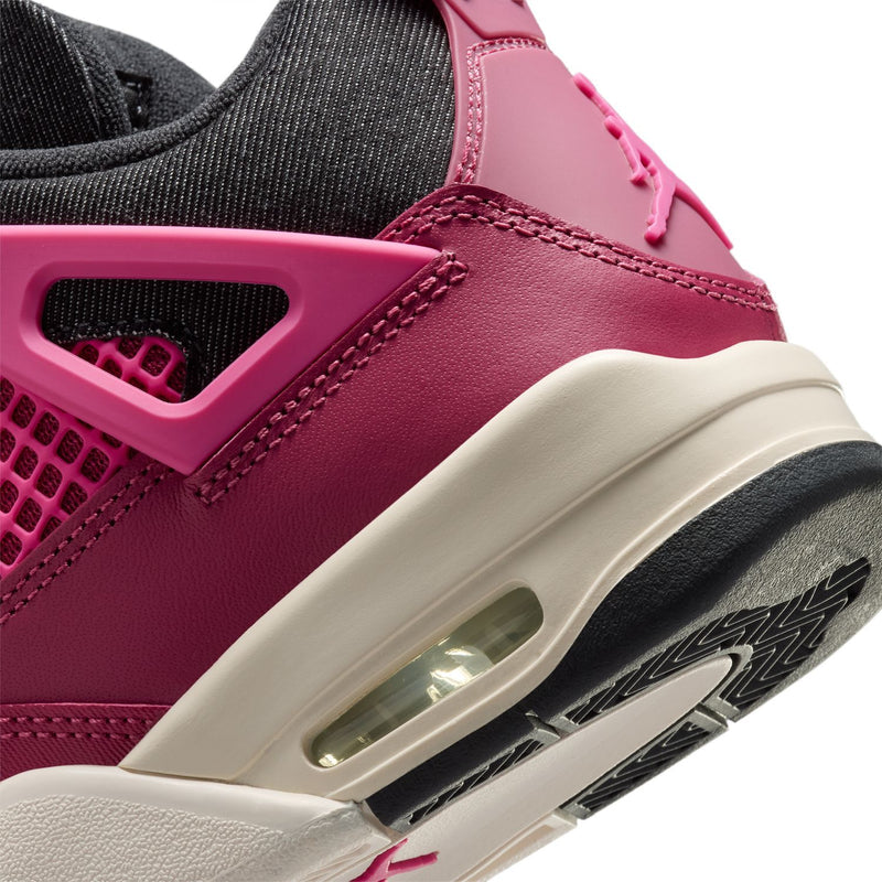 Close-up youth sneaker side with pink air unit window and off-white sole trim