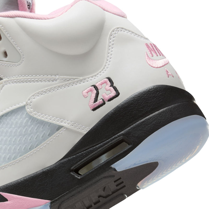 White leather-look sneakers with 23 marking and black outsole, pink midsole accents