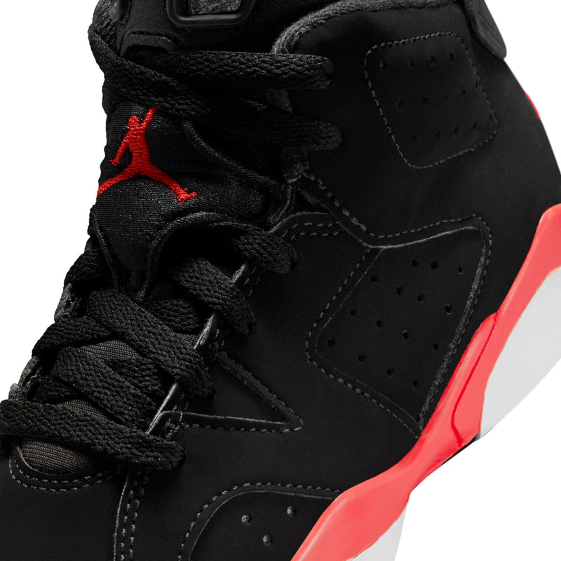 Close-up kids black high-top sneaker with laces, stitched panels, and red trim