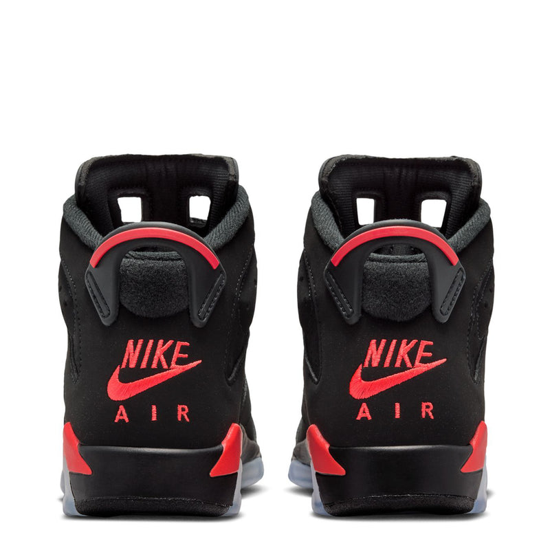 Youth black sneakers with red Nike Air logo on heel