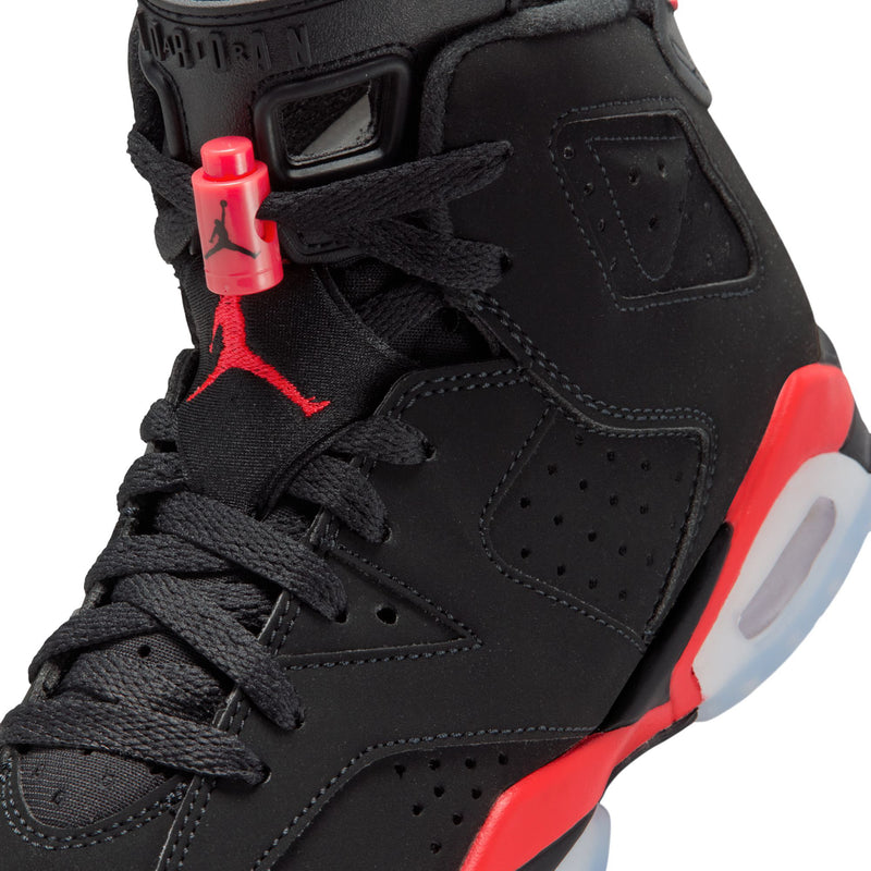 Close-up of youth black high-top sneaker with red lace loops and Jordan branding