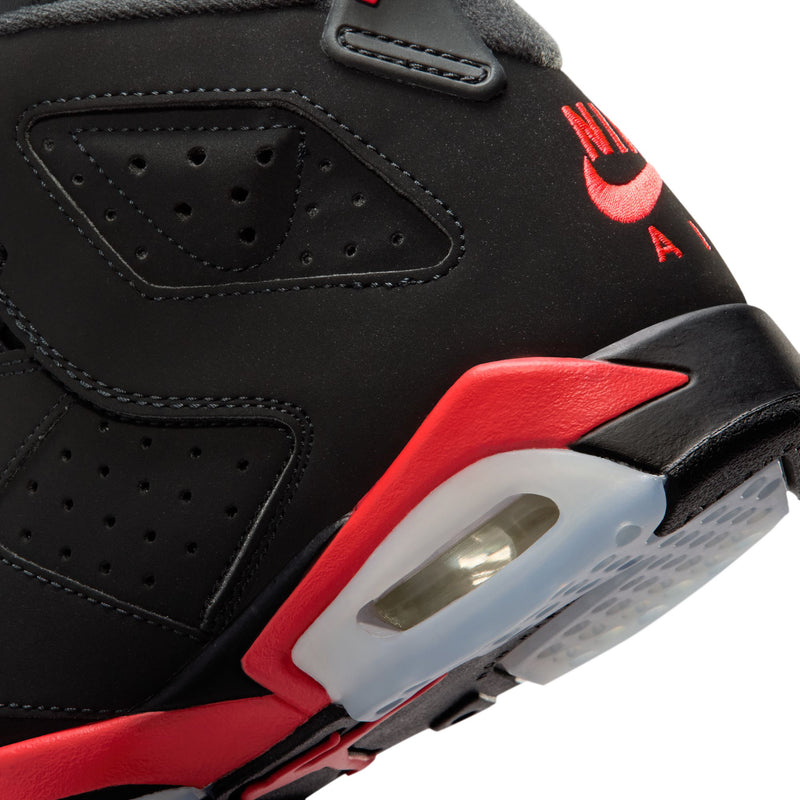 Black youth sneaker side panel with perforations, red trim, and Air unit