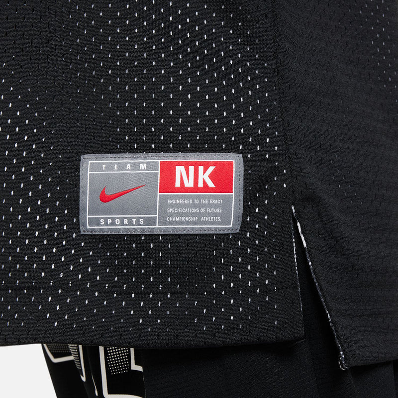 Youth reversible jersey size label patch on black sleeveless mesh tank.