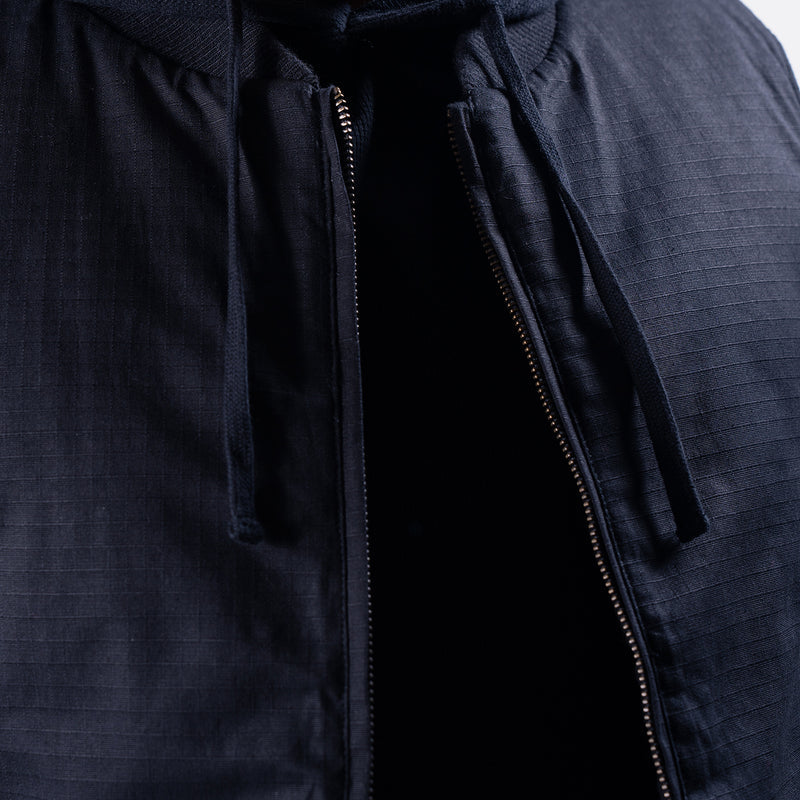 Black ripstop hooded vest fabric with visible full-zip and zipper pull