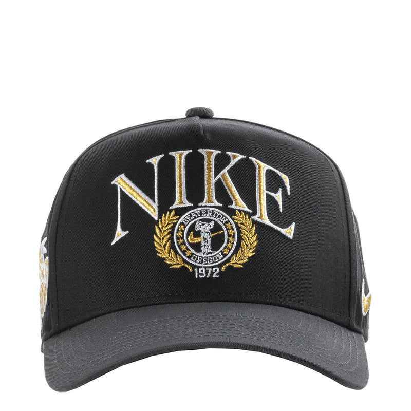 Black structured snapback cap with curved bill, front Nike crest logo