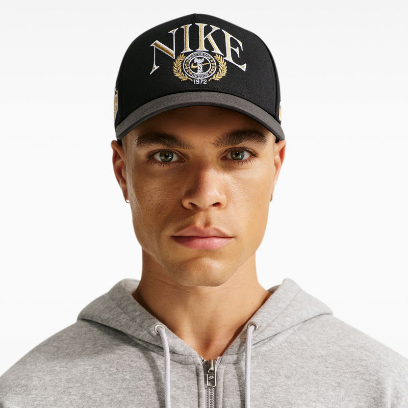 Black Nike structured snapback cap with curved bill and front embroidery logo