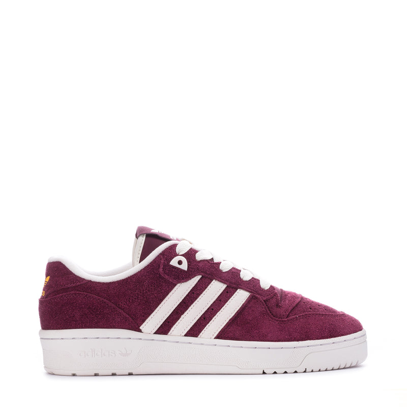 Men's burgundy suede low-top sneakers with white adidas stripes and laces.