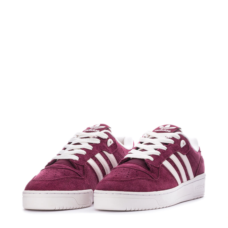 Pair of men's burgundy suede low-top sneakers with white laces and stripes.