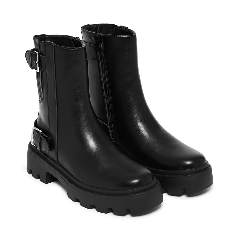 Black leather boots with buckle details on a white background