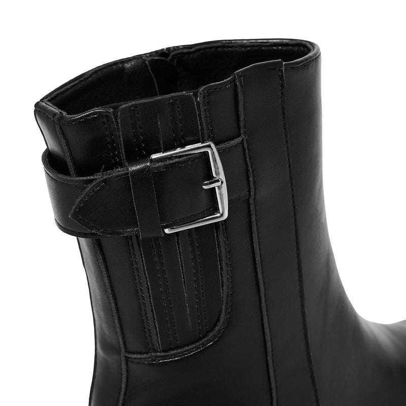 Black rain boot with a buckle on a white background