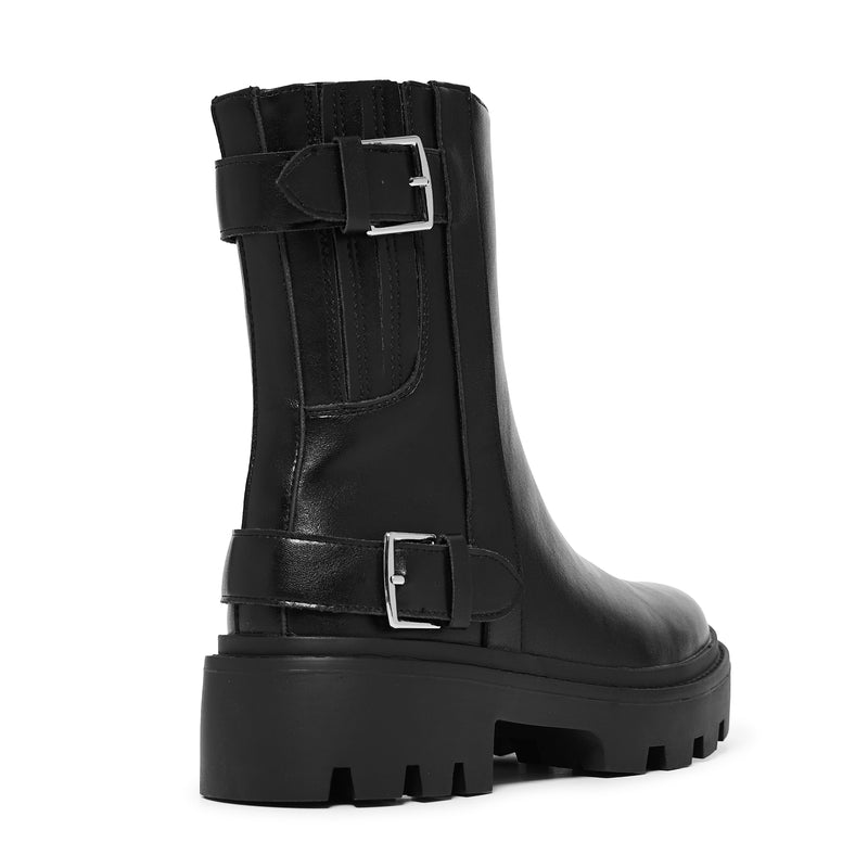 Black boot with buckle details on a white background