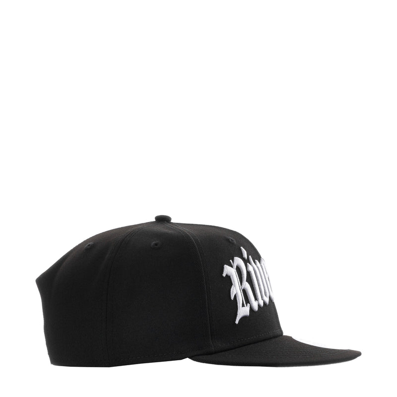 Black snapback cap with side white embroidered text and curved brim