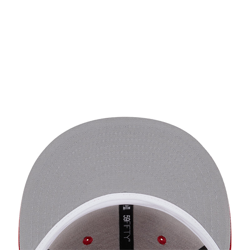Gray cap interior view with red eyelets and brand tag