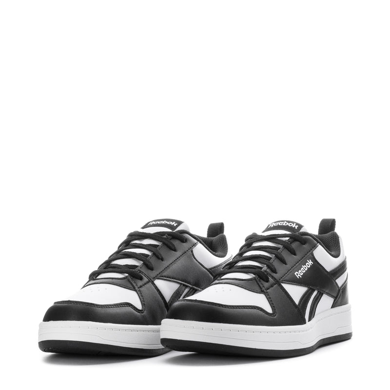 Pair of youth Reebok sneakers, black-and-white low-top with lace-up and side stripes
