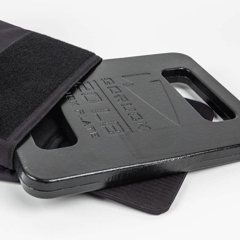 GORUCK 20LB ruck plate in black partially inserted into a rucksack pocket on white background