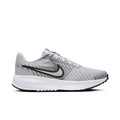 Men's running shoe in light grey knit with black swoosh and white sole, lace-up.