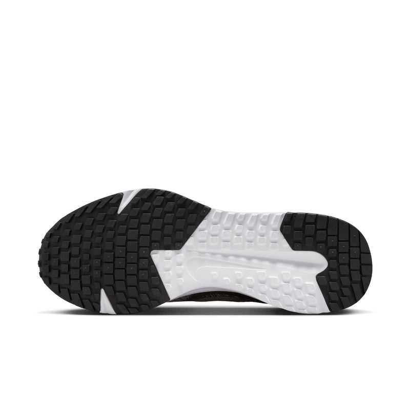 Outsole view of men's running shoes with black tread pattern and white midsole edge