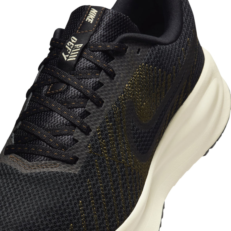 Men's Nike running shoe, black knit upper with lace-up and gold accents