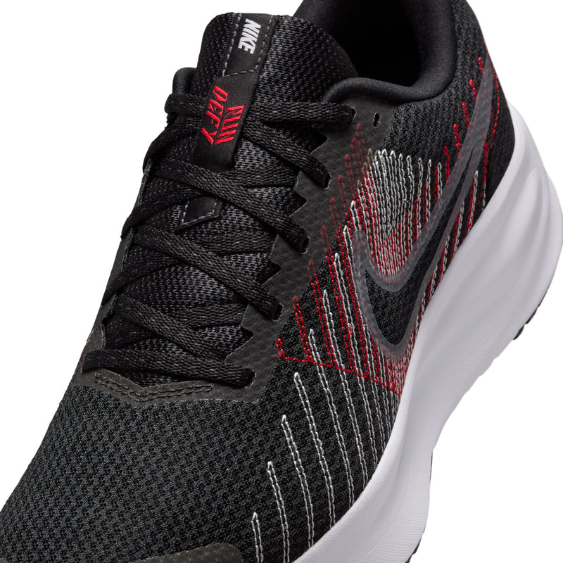 Close-up of black mesh running shoe laces and red/gray stripe pattern, white sidewall