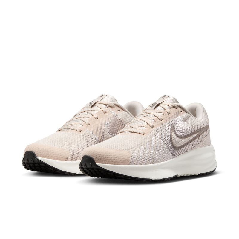 Light beige women's running shoe with lace-up knit texture and white midsole.