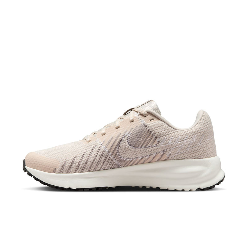 Light beige women's running shoe with Nike swoosh and ribbed overlay detail.