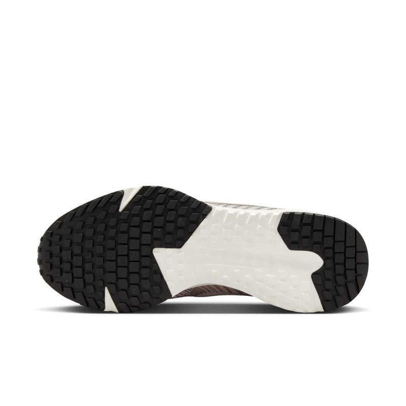 Light beige women's running shoe outsole with textured tread and black rubber pods.