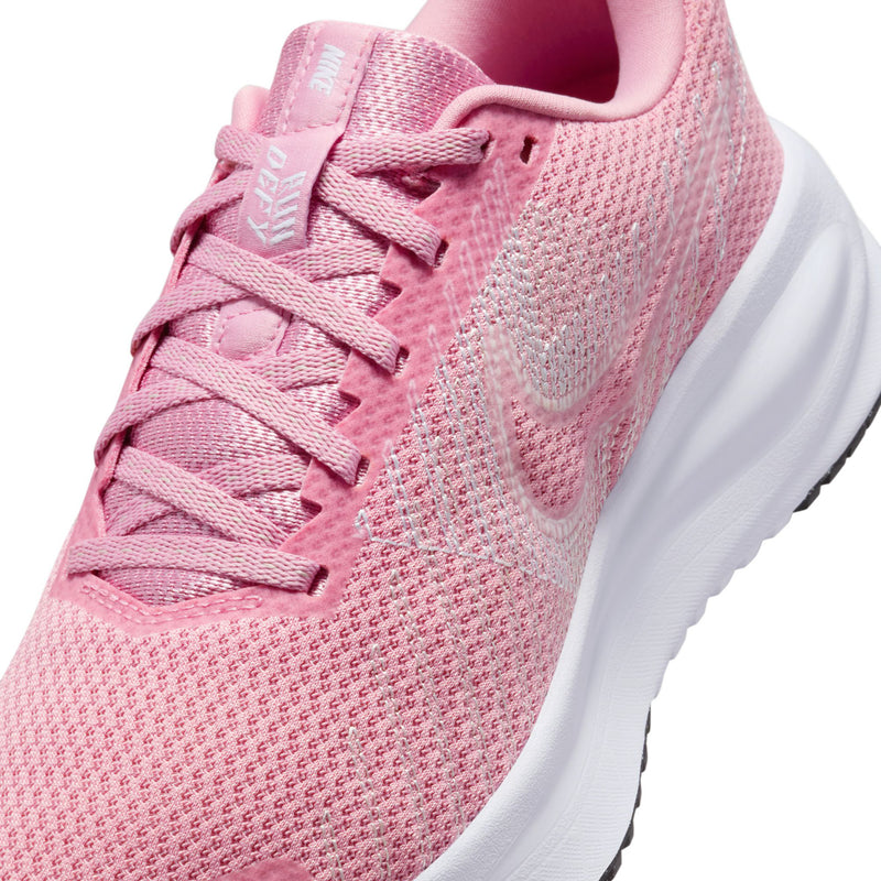 Women’s running shoes close-up: pink knit upper with lace-up and padded collar
