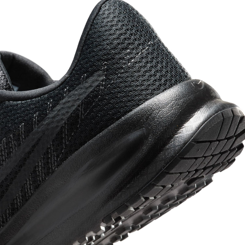 Side close-up of black running shoe with textured knit and durable rubber sole