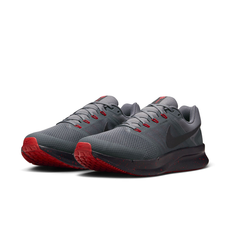 Pair of men's dark gray running shoes with red soles and lace-up eyelets