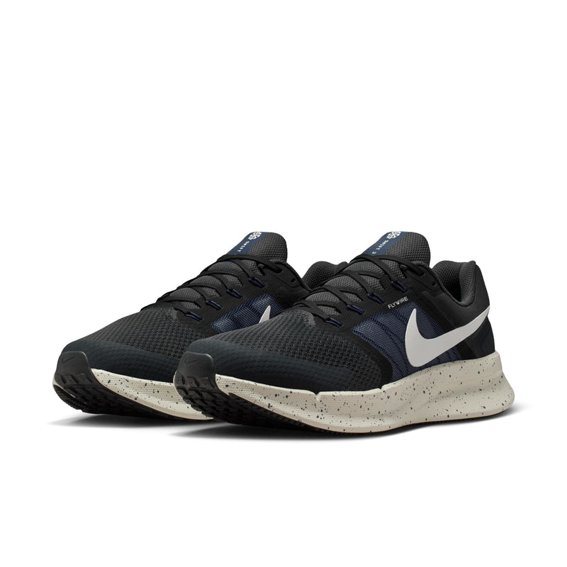 Mens pair of dark navy/black running sneakers with white swoosh and speckled midsole