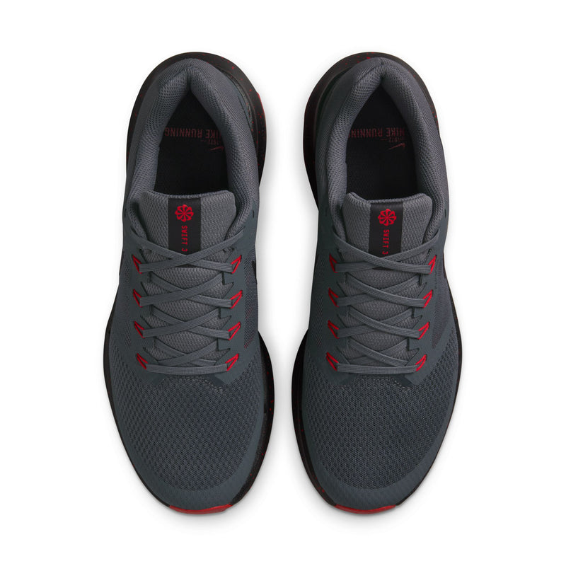 Men's dark gray running shoes, top view of laces and red logo tongue