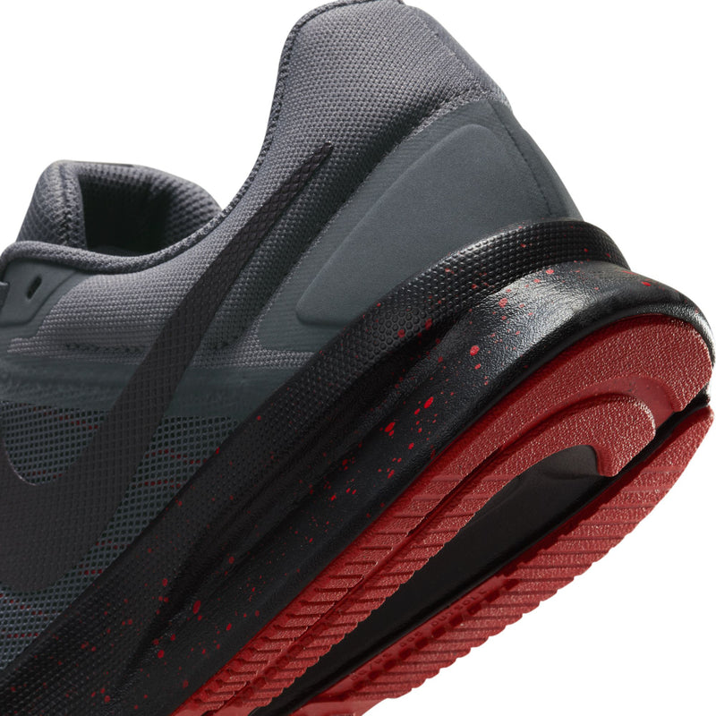 Close-up of men's dark gray running shoes with red-accented midsole and heel