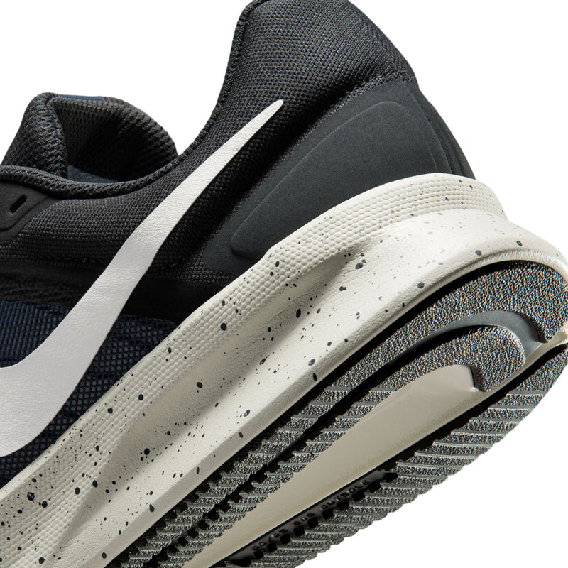 Mens running shoe side close-up showing white swoosh and speckled midsole detail