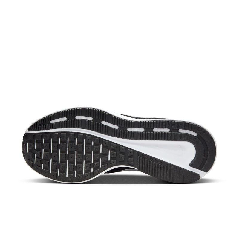 Black rubber outsole with white midfoot panel and tread pattern for traction.