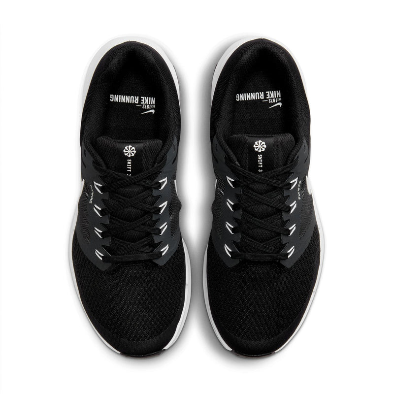 Black lace-up sneakers with mesh uppers and white logo text at the tongue.
