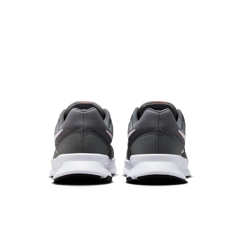 Back view of dark gray running shoes with white heel sole and padded collar