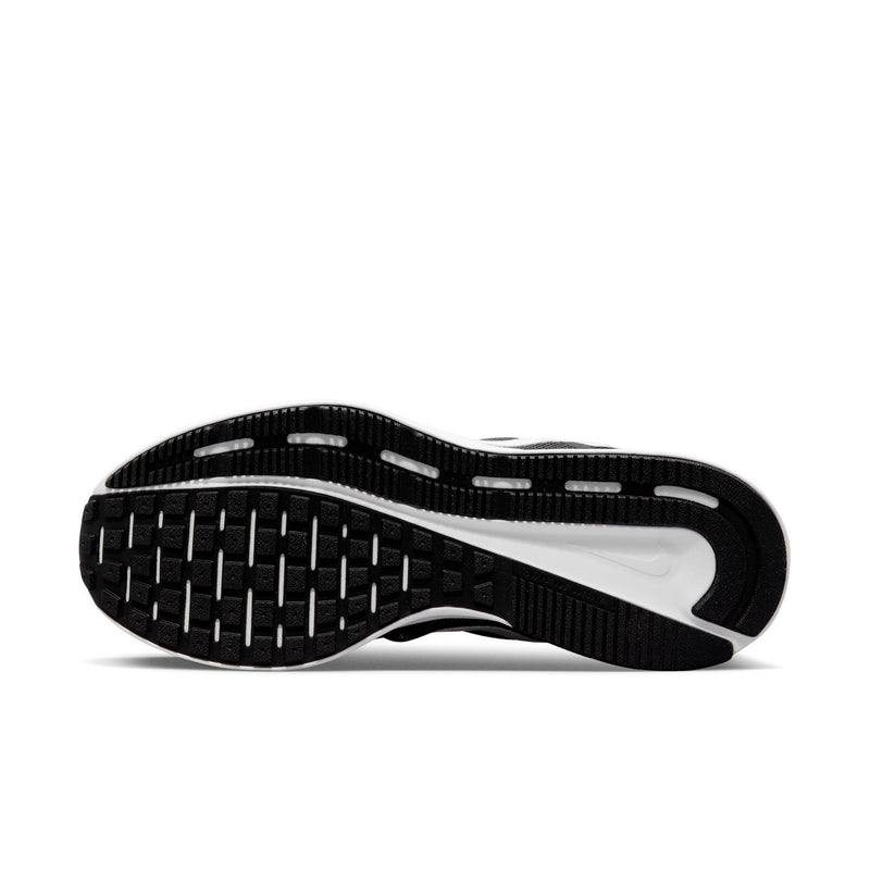 Black rubber outsole with white traction sections on a running shoe bottom view.