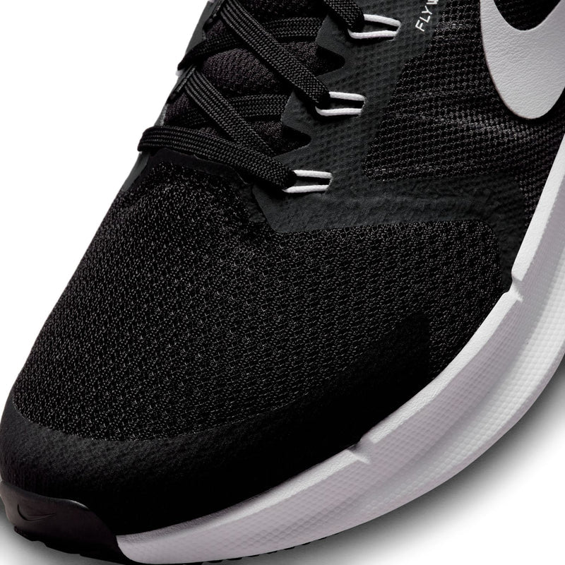 Black knit upper close-up with lace-up eyelets and white Nike swoosh detail.