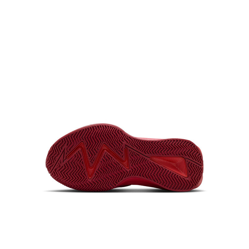 Kids red outsole on black and red sneakers with textured herringbone tread