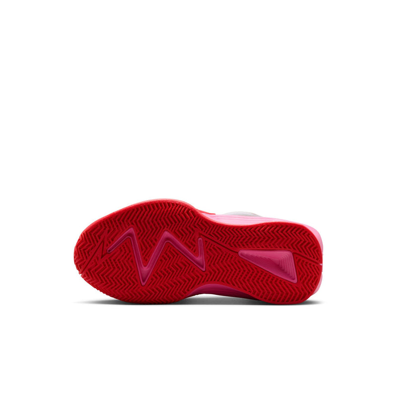 Kids' red outsole with textured tread on white and pink sneakers