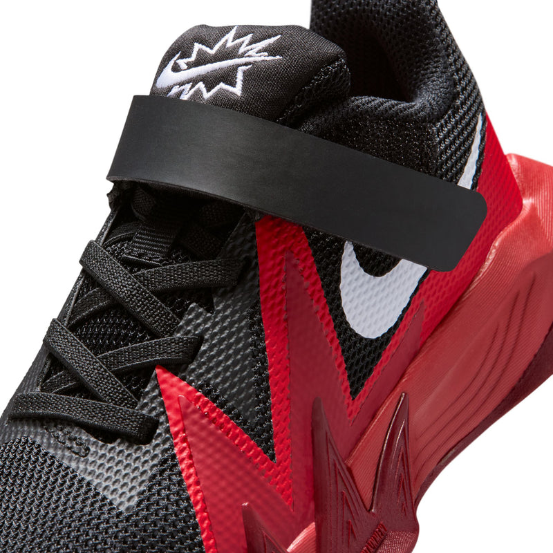 Kids black mesh shoe with red lightning accents and gray swoosh, close-up